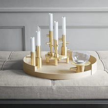 Cargar imagen en el visor de la galería, Decorative brass candle holder with white candles on a gray sofa