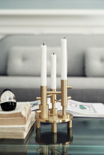Cargar imagen en el visor de la galería, Gold candle holder with white candles on a glass table