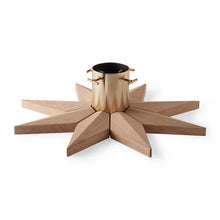 Load image into Gallery viewer, Star-shaped wooden tree holder with a brass center on a white background