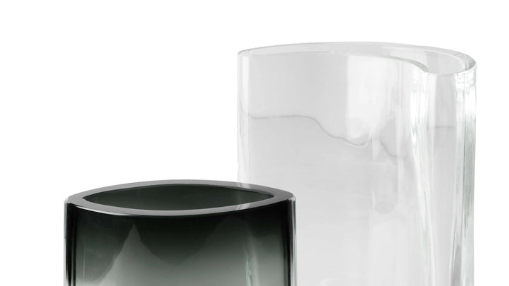 Two cylindrical objects, one black and one clear, on a white background