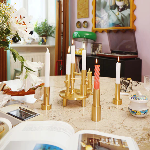 Decorative candle holders on a table with a blurred indoor background