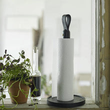 Cargar imagen en el visor de la galería, Roll of paper towels on a stand with a plant and bottle in the background
