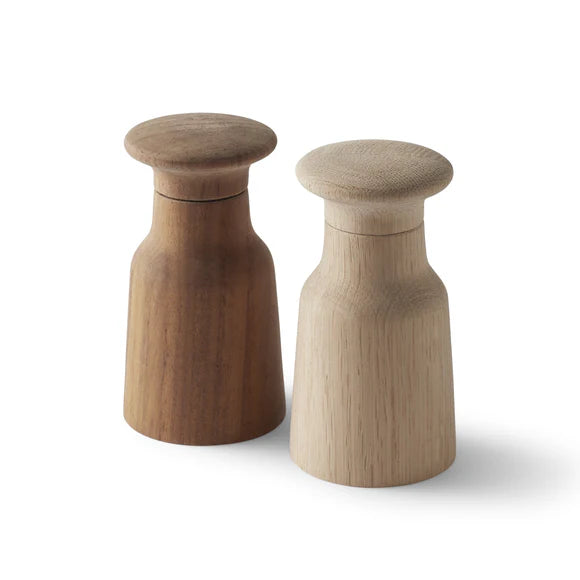 Two wooden salt and pepper shakers on a white background