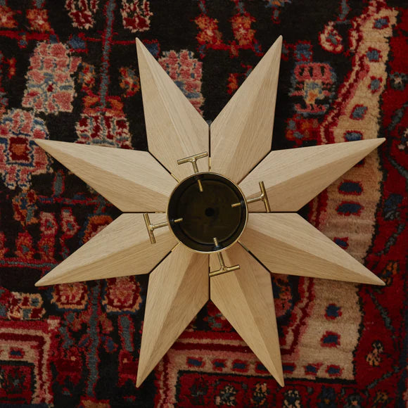 Wooden star-shaped object on a patterned rug