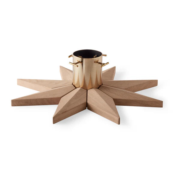 Star-shaped wooden tree holder with a brass center on a white background